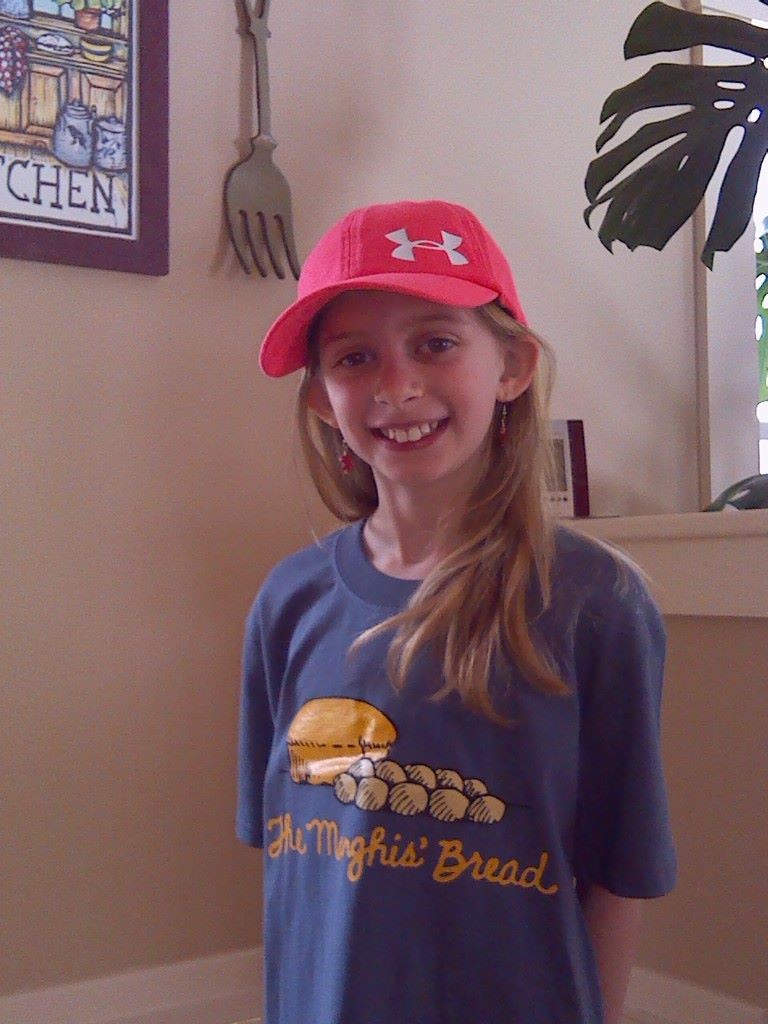 Stella models the slate blue Manghis' T-shirt.